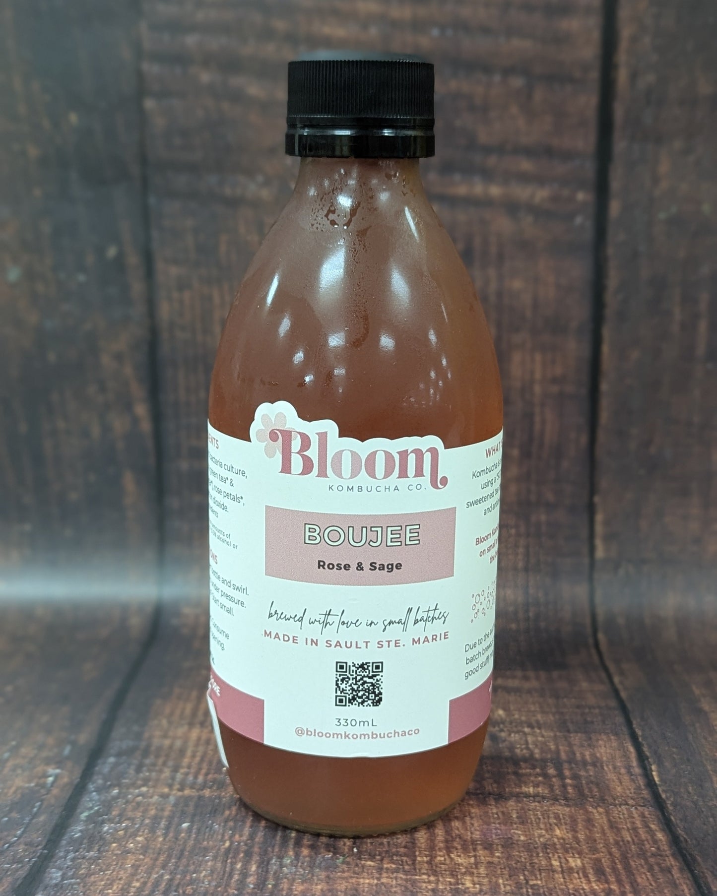 Bottle of 'Bloom' kombucha on a wooden surface