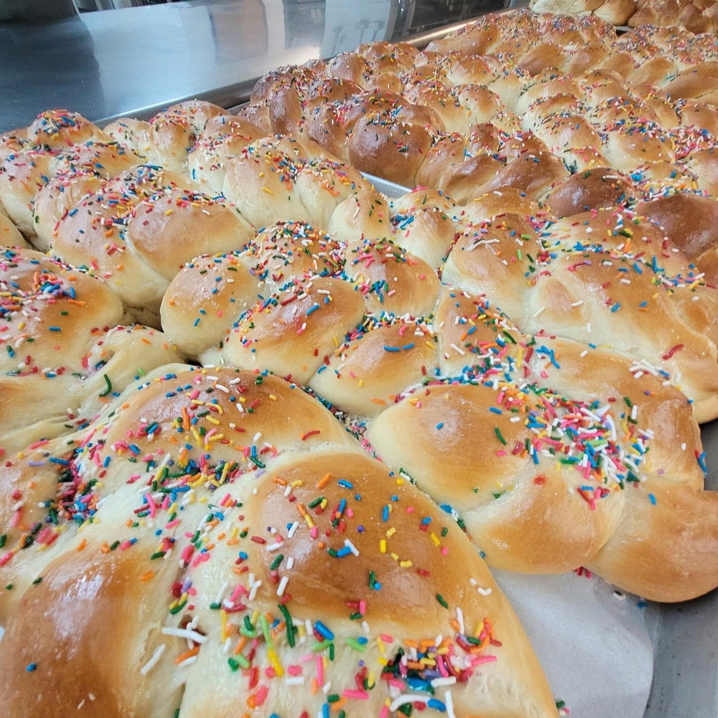 batches of freshly baked Easter bread topped with multicolored sprinkles