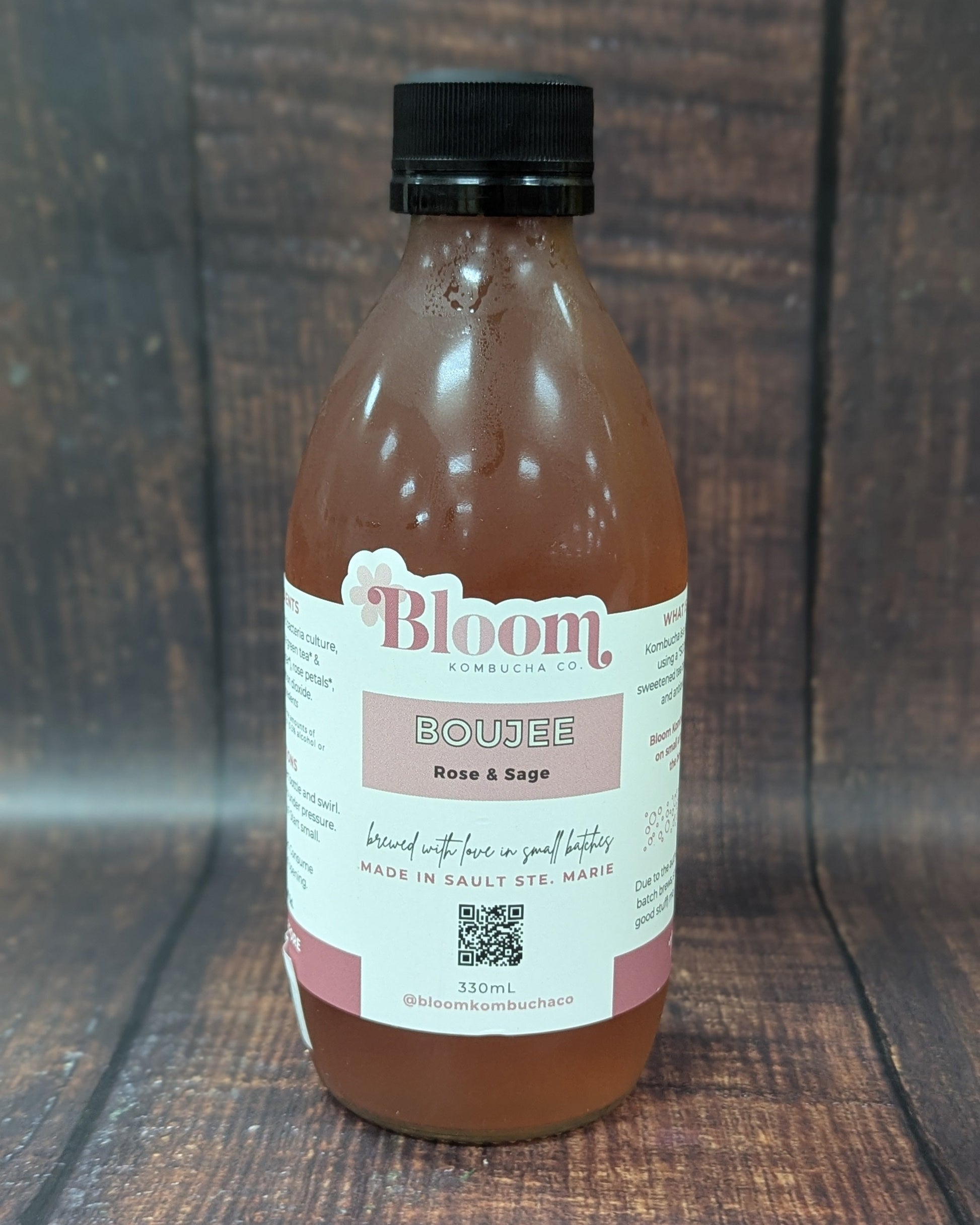 Bottle of 'Bloom' kombucha on a wooden surface