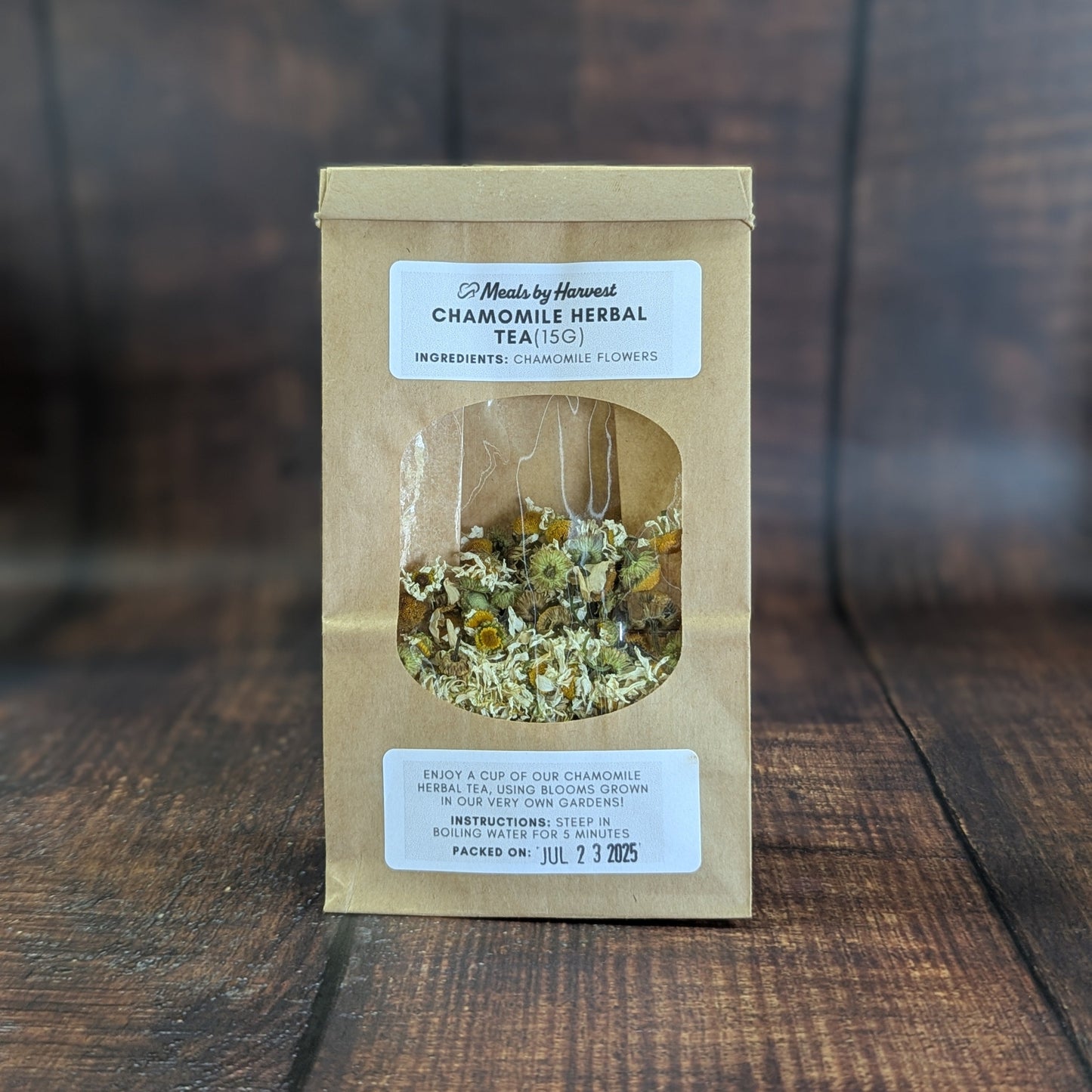 Packaged chamomile herbal tea on a wooden surface with a blurred background