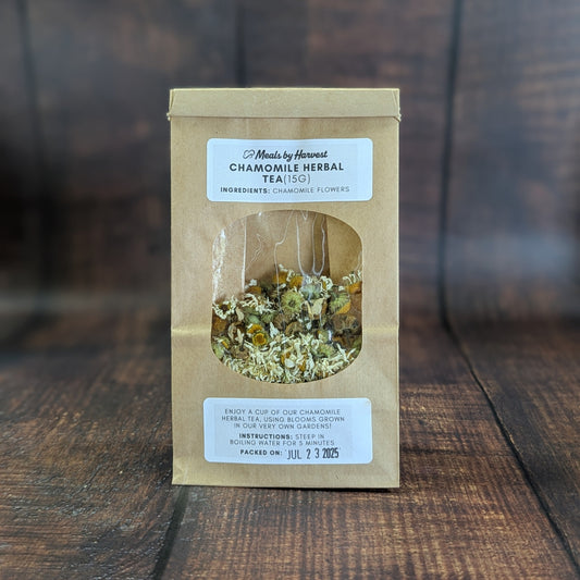 Packaged chamomile herbal tea on a wooden surface with a blurred background